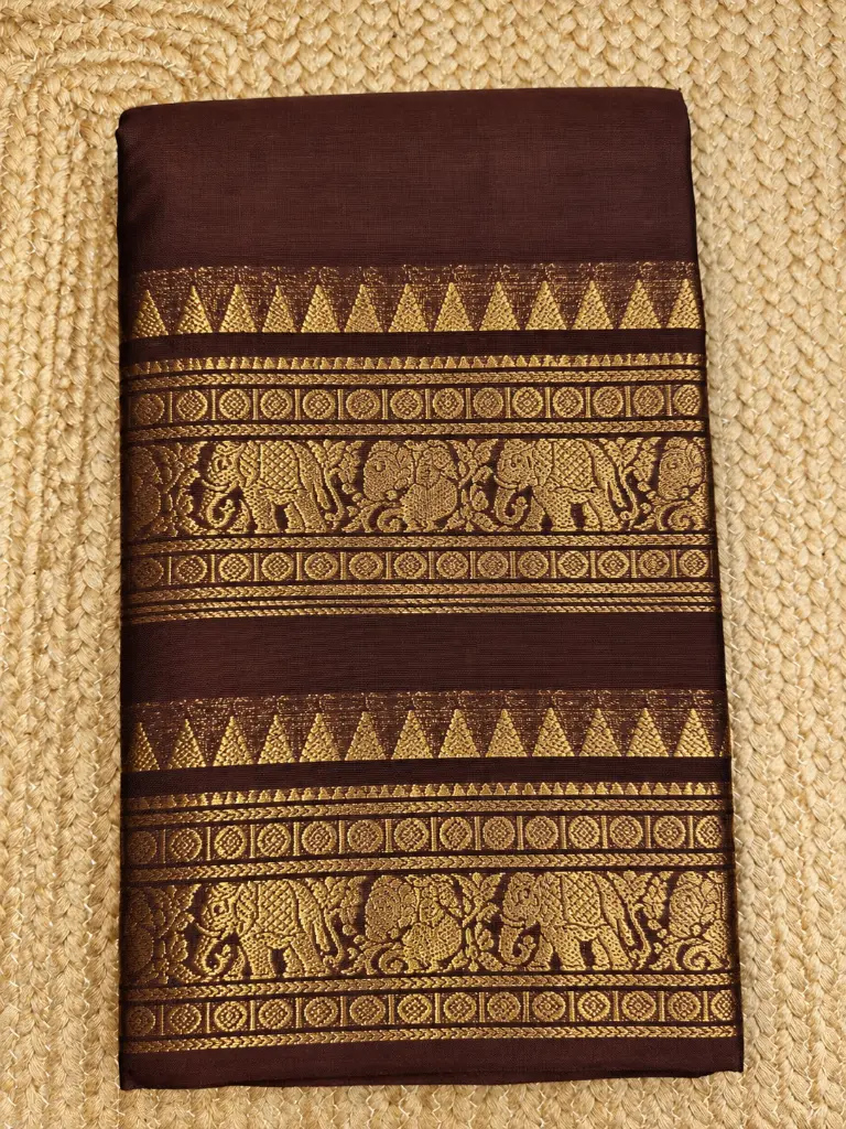 Chocolate Brown Saree with Gold Elephant Borders.webp