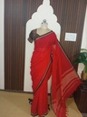 Bright red handloom cotton saree with a brown woven border